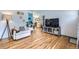 Bright and airy living room featuring beautiful hardwood floors, a comfortable sofa, and a built-in bookcase at 2201 S Lowell Blvd, Denver, CO 80219
