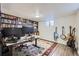 Functional office with built-in shelves, monitors and natural light at 2201 S Lowell Blvd, Denver, CO 80219