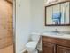 Bathroom featuring updated vanity with granite countertops and tiled shower at 1145 W 101St Ave, Northglenn, CO 80260