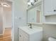 Bathroom boasts a white vanity with a mirror and a white cabinet at 1145 W 101St Ave, Northglenn, CO 80260