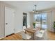 Dining room with modern light fixture, table set and access to kitchen at 1145 W 101St Ave, Northglenn, CO 80260