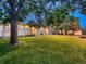 Beautifully landscaped backyard featuring a brick home and mature shade trees at 1145 W 101St Ave, Northglenn, CO 80260