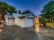 Attached garage with a paved driveway and manicured landscaping at 1145 W 101St Ave, Northglenn, CO 80260