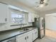 This bright kitchen features modern appliances, a stainless steel sink, and a view to the backyard at 1145 W 101St Ave, Northglenn, CO 80260