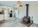 Cozy living room with wood burning stove adjacent to the modern kitchen at 1145 W 101St Ave, Northglenn, CO 80260