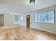 Inviting living room with hardwood floors, built-in shelving, and a large window at 1145 W 101St Ave, Northglenn, CO 80260