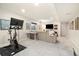 Finished basement with comfortable seating, a workout area, and entertainment setup at 10788 Ventura St, Commerce City, CO 80022
