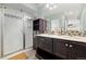 Elegant bathroom with a glass-enclosed shower, double vanities, and modern finishes at 10788 Ventura St, Commerce City, CO 80022
