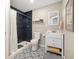 Bathroom with a tiled shower, decorative floors, and a white vanity with storage space at 10788 Ventura St, Commerce City, CO 80022