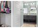 Ensuite bathroom with dual sinks, a shower, and a walk-in closet at 10788 Ventura St, Commerce City, CO 80022