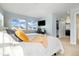 Cozy bedroom featuring a large bed, windows, and ensuite bathroom at 10788 Ventura St, Commerce City, CO 80022