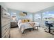 Bright and airy bedroom with three windows, a large bed, and carpet floors at 10788 Ventura St, Commerce City, CO 80022