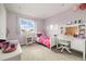 Bright bedroom features a large window, a cozy bed, and a functional desk area at 10788 Ventura St, Commerce City, CO 80022