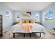Well-lit bedroom with three windows, a large bed, and carpet floors at 10788 Ventura St, Commerce City, CO 80022