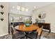 Dining area showcases a wooden table, chairs, and view of stainless steel appliances at 10788 Ventura St, Commerce City, CO 80022