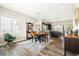 Open-concept dining area with hardwood floors adjacent to modern kitchen and backyard access at 10788 Ventura St, Commerce City, CO 80022