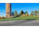Community tower and entrance featuring manicured landscaping and a clear blue sky backdrop at 10788 Ventura St, Commerce City, CO 80022