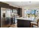 Modern kitchen features stainless steel appliances, an island, and access to the backyard at 10788 Ventura St, Commerce City, CO 80022