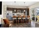 Stylish kitchen island with seating, stainless steel appliances, and dark wood cabinets at 10788 Ventura St, Commerce City, CO 80022