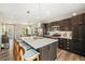 Bright, modern kitchen with a large island, stainless steel appliances, and barstool seating at 10788 Ventura St, Commerce City, CO 80022