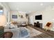 Comfortable living room featuring an area rug and a sectional sofa at 10788 Ventura St, Commerce City, CO 80022