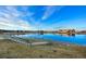 Scenic pond view reflecting the blue sky and community buildings in this idyllic setting at 10788 Ventura St, Commerce City, CO 80022