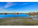 Reflective pond surrounded by a walking path offering picturesque community views and blue sky at 10788 Ventura St, Commerce City, CO 80022