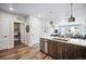 Modern kitchen with island, stainless steel appliances, and laundry area at 20 Wilcox St # 314, Castle Rock, CO 80104