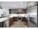 Modern kitchen with stainless steel appliances and wood cabinets at 20 Wilcox St # 314, Castle Rock, CO 80104