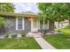 Charming single-Gathering home featuring a stone facade and a well-manicured front yard with mature landscaping at 1250 S Monaco Street Pkwy # 49, Denver, CO 80224