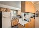 Efficient kitchen with a combination of appliances and cabinetry and in-unit laundry at 1250 S Monaco Street Pkwy # 49, Denver, CO 80224