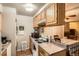 Functional kitchen with ample cabinet space, appliances, and an adjacent dining area at 1250 S Monaco Street Pkwy # 49, Denver, CO 80224