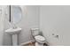 Clean powder room featuring a modern pedestal sink and toilet at 9092 Telluride Ct, Commerce City, CO 80022