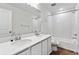 Bathroom features double sinks, a large mirror, and a shower-tub combination at 9092 Telluride Ct, Commerce City, CO 80022