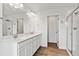 A modern bathroom features double sinks, a large mirror, and a glass-door shower at 9092 Telluride Ct, Commerce City, CO 80022