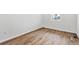 Bright bedroom featuring sleek wood floors and ample natural light from the window at 9092 Telluride Ct, Commerce City, CO 80022