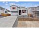 Charming gray two-story home with a cozy front porch and well-maintained landscaping at 9092 Telluride Ct, Commerce City, CO 80022
