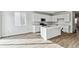 Contemporary kitchen with a center island, stainless steel appliances, and ample cabinet space at 9092 Telluride Ct, Commerce City, CO 80022