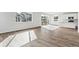 Bright living space with large windows and hardwood floors, adjacent to a modern kitchen at 9092 Telluride Ct, Commerce City, CO 80022