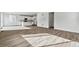 Spacious open-concept layout with modern flooring, connecting kitchen and living areas at 9092 Telluride Ct, Commerce City, CO 80022