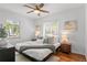 Bright bedroom with modern design, stylish ceiling fan, hardwood floors, and natural light at 1177 Wabash St, Denver, CO 80220