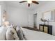 Modern bedroom featuring hardwood floors, white walls, and large bed with neutral colored pillows at 1177 Wabash St, Denver, CO 80220