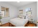 Bedroom with hardwood floors, two windows providing natural light, and a modern design at 1177 Wabash St, Denver, CO 80220