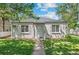 Charming single-story home featuring a well-kept lawn, grey paint and easy access to the front door via a sidewalk at 1177 Wabash St, Denver, CO 80220