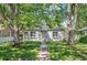 Charming single-story home featuring a well-kept lawn, grey paint and mature landscaping at 1177 Wabash St, Denver, CO 80220