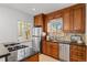 Well-lit kitchen features stainless steel appliances, granite countertops, and wood cabinets at 1177 Wabash St, Denver, CO 80220