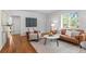 Bright living room boasts hardwood floors, neutral decor and comfortable seating arrangements at 1177 Wabash St, Denver, CO 80220