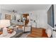 Bright living room boasts hardwood floors, with bar seating and easy access to the kitchen at 1177 Wabash St, Denver, CO 80220