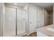 Bathroom with glass enclosed walk-in shower and vinyl flooring at 48260 Shetland Dr, Bennett, CO 80102