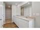 Bathroom with double vanity, quartz countertop, modern lighting and vinyl floors at 48260 Shetland Dr, Bennett, CO 80102